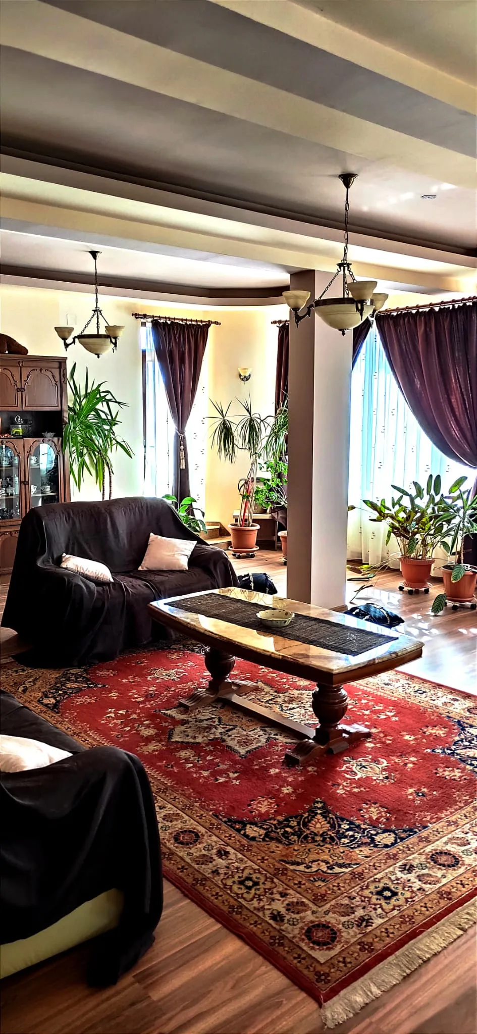 Guest house living and dining area with chandeliers and wood furniture