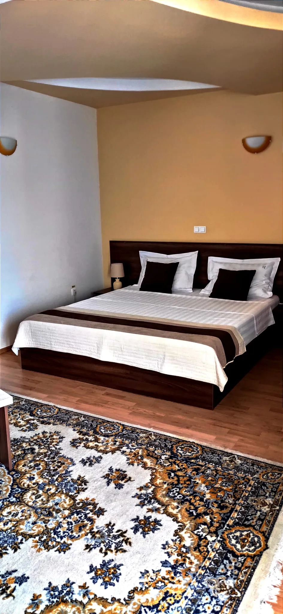 Superior room with king-size bed, cream linen and wrought-iron balcony